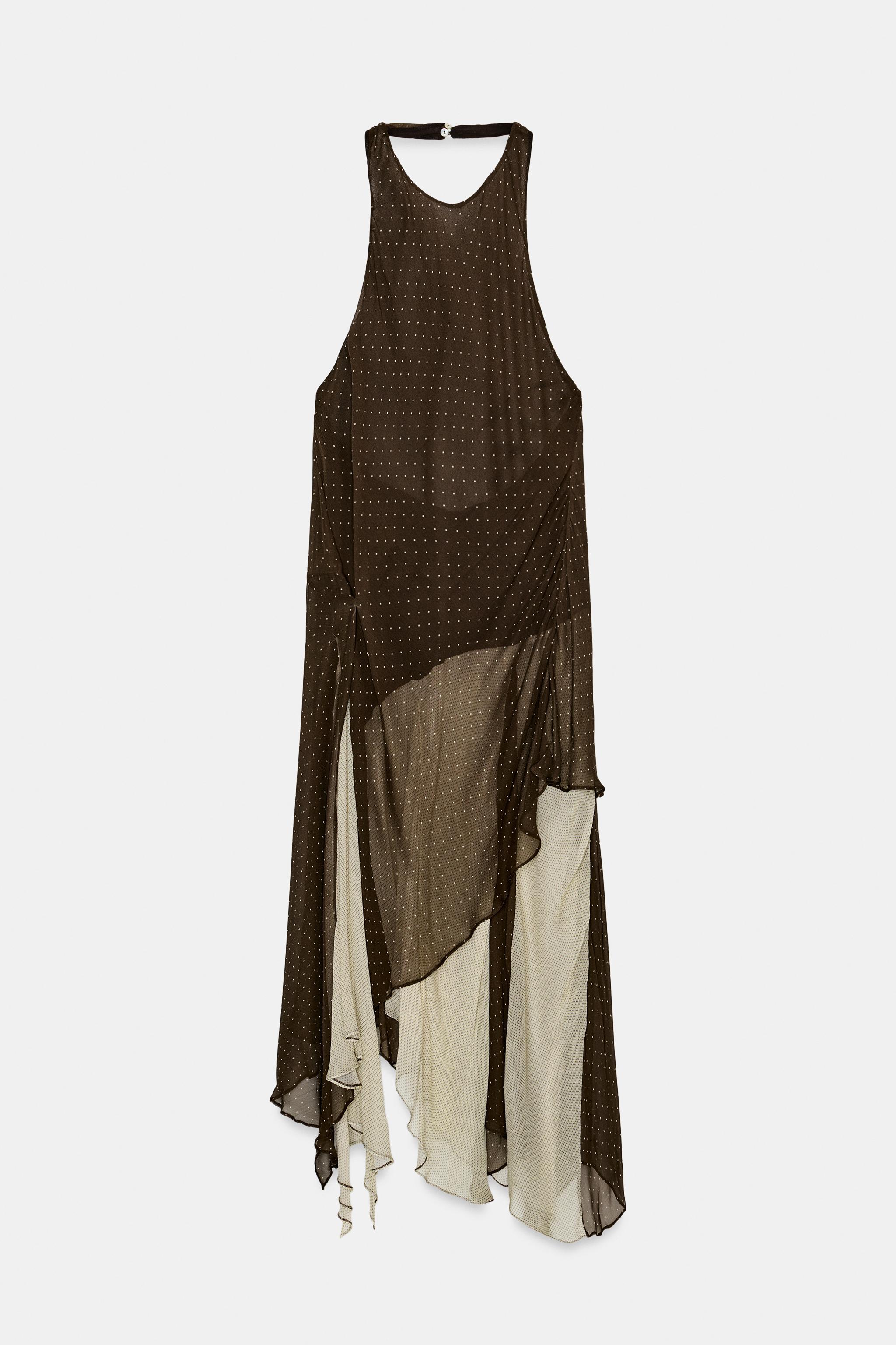 Vestido midi de Zara en blanco y negro con cuello halter y volantes, ideal para la Feria de Abril. (Fuente: El Mundo)